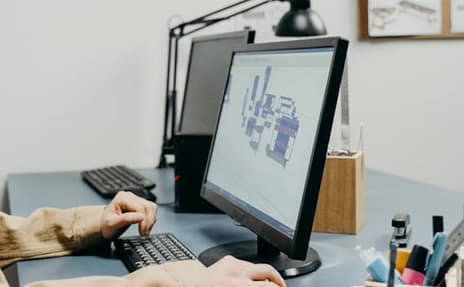 mind-mapping-software A man focused on his work, sitting at a desk and using min mapping software