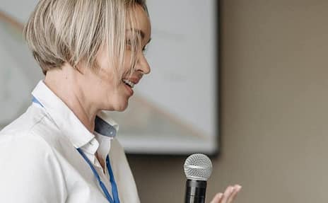 speech-recognition A woman speaking into a microphone